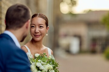 Bride and Groom Sharing a Tender Moment on Their Wedding Day Outdoors
