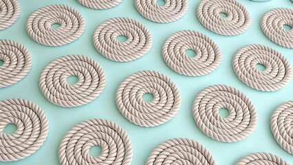 Neatly coiled natural fiber ropes creating a rhythmic pattern on a tranquil surface