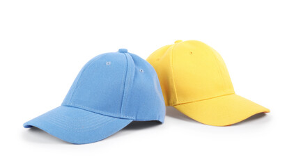 Blue and yellow baseball caps isolated on white. Mockup for design