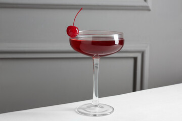 Tasty cherry cocktail on white table, closeup