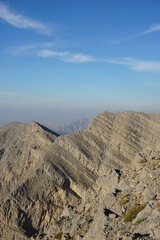 A panoramic view of rugged mountains viewed from the hiking trail to the flag at Jebel Jais in the...