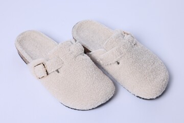 Pair of stylish slippers on white background, closeup