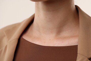 Woman with healthy skin on light background, closeup