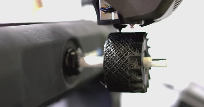 3d printer printing a small wheel isolated on white background