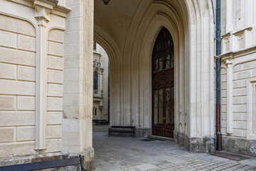 Gothic-style archway entrance with detailed stonework and wooden doors in historic building