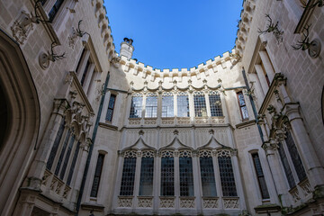 Gothic revival architecture of hluboka castle courtyard under blue sky