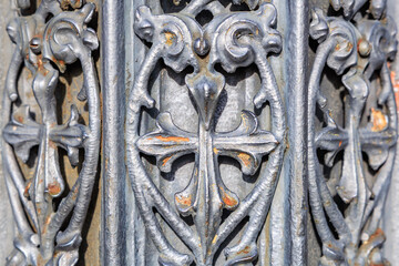 Intricate ironwork design with weathered patina close-up