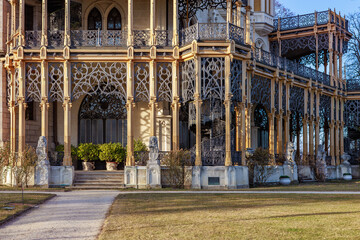 Ornate ironwork and stone lions adorn historic european mansion