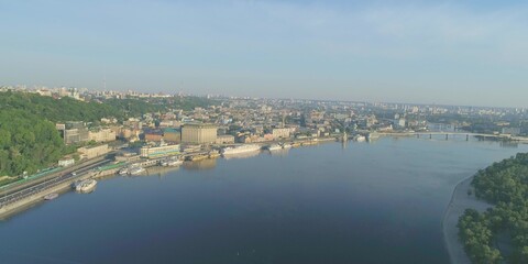 Bridge road crossing river, riverfront and riverbank, sunlight summer landscape