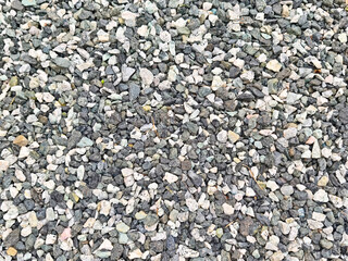Textured gravel surface with small rocks and pebbles suitable for various landscaping projects and...