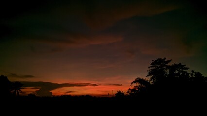 Dramatic Sunrise with Silhouette Trees in Countryside