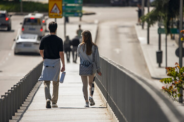 Young couple walking through  the colorful old facades creating a picturesque backdrop for their...