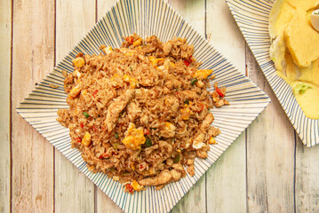 Cylinder-cooked pork chaufa with caramelized crust, spring onion, and yellow chili, an intense take on the classic chifa