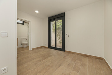 Unfurnished room with walnut flooring, highlighting the beauty of the wood in a serene setting