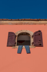 Bosnia Herzegovina, Europe: window with iron shutters and pants hanging out to dry in the Old Bazaar Kujundziluk, muslim quarter of the old town of Mostar with its colorful houses and craft shops