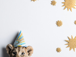 Fototapeta premium Lion Cub Birthday Party Adorable Celebration Whimsical Hat Decorations Gold Stars Cute Animal Festive Happy Joyful Event Fun Lively Playful Paw Cheerful Toddler Family Colorful Smile Sweet Innocent