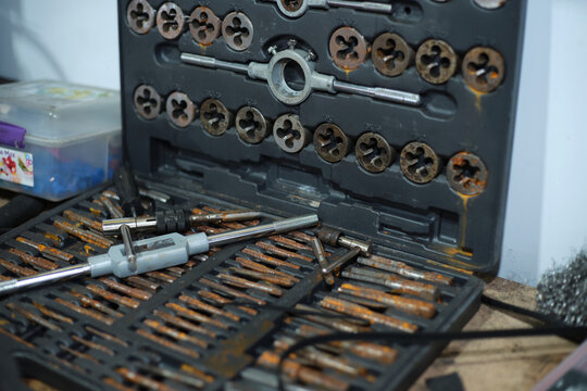 Tool kit containing various taps and dies for threading
