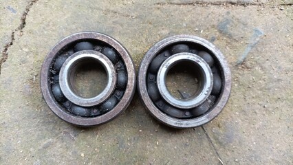 two used bearings on a motorcycle.