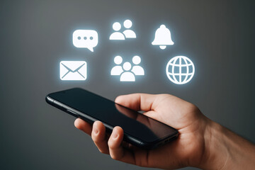 Hand holding smartphone with glowing social media and people icons floating above mobile