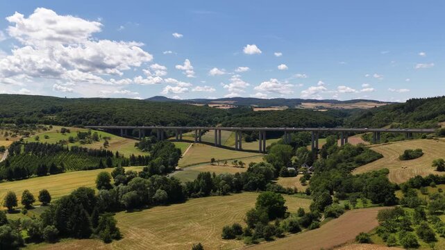 Tall bridge, tall brucke over a valley, highway infrastructure in Germany. Aerial video.