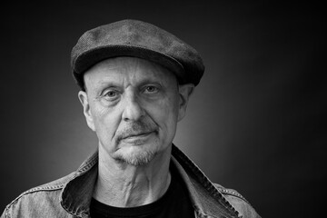 Portrait of a senior man in a vintage Harcourt style lighting