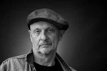 Portrait of a senior man in a vintage Harcourt style lighting