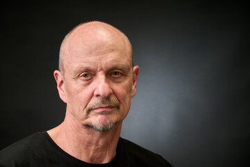 Portrait of a senior man in a vintage Harcourt style lighting