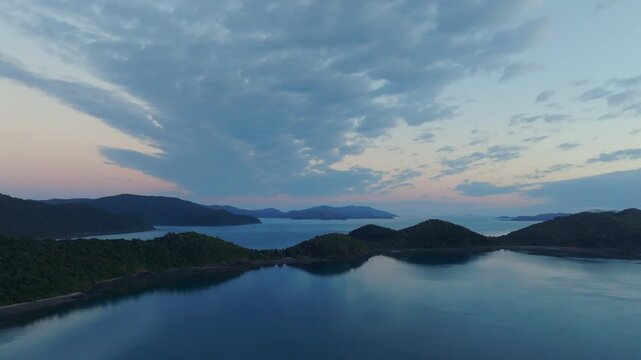 Big wide drone shot of Long Island and the mainland towards Shute Harbour in the Whitsundays, QLD, Australia