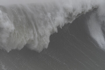 Dark ocean waves crashing and creating white foam during a fierce storm, showcasing the raw power...