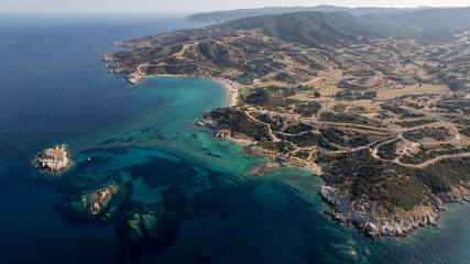 Aerial view of Toroni, Halkidiki, Greece, capturing the stunning turquoise waters, rocky coastline,...