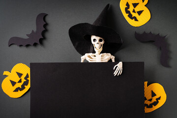 Halloween mockup with skeleton in witch hat and blank board