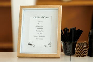 Coffee menu with a list of different types hot drinks for guestsPrinted coffee menu stands on the...