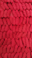 The texture of the red carpet with a caterpillar-like pattern is suitable for use on various backgrounds.