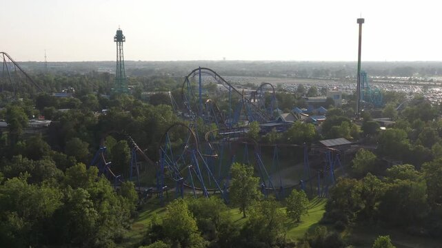 Aerial view of the thrilling roller coasters and towering structures of Kings Island amusement park amidst lush greenery, Mason, Ohio, United States.