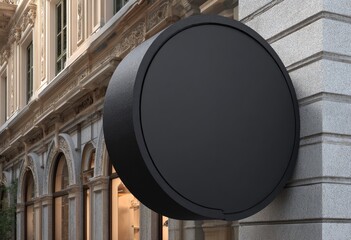 Black circular sign on building exterior