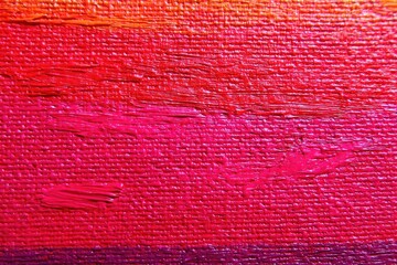 Abstract close-up of vibrant, textured, painted canvas in hues of red, orange, and purple