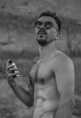Handsome man with athletic torso with perfume