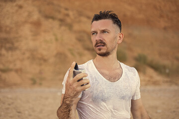 Handsome guy with perfume by the sea