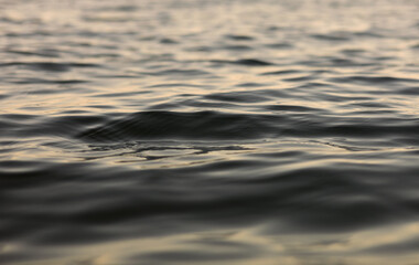 water with ripples on the surface. Defocus blurred transparent blue colored clear calm water...