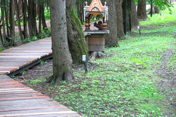 Arboretum path with wooden squirrel feeder in Pereslavl-Zalessky