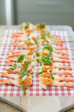 Row of prawn platter on chopping board ready to be served
