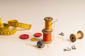 Sewing equipment for tailoring or handicrafts.
Vintage wooden spools of thread, buttons and thimble...