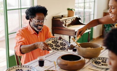 Joyful Brazilian family sharing a traditional meal together