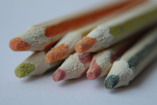 Brightly colored glue sticks, close-up detail view against a white background