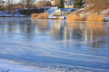 Frozen lake reflecting winter houses