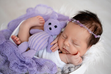 sleeping newborn baby girl in a crib, space and room for text