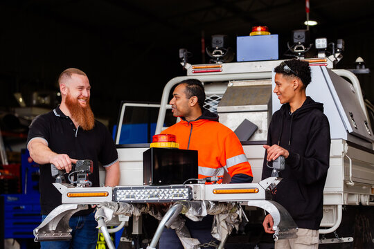manufacturing workers standing with completed light bar ready to fit to new mining fleet vehicle