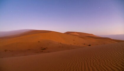 Sunrise or sunset over a vast dune landscape