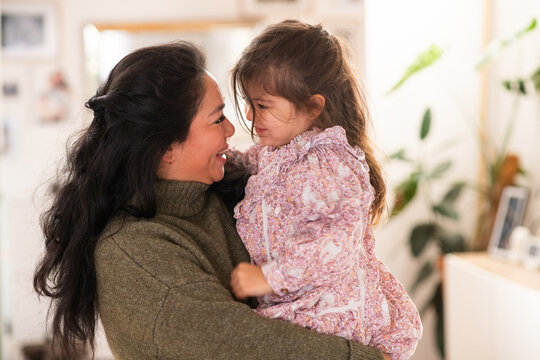 mother holding her young daughter in her arms