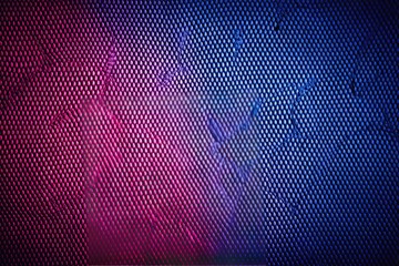 Abstract, textured, mesh pattern; vibrant gradient of red, purple, and blue